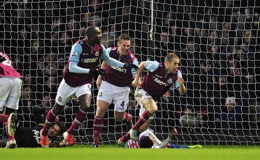 West Ham's Joe Cole (R) celebrates scoring the equaliser against Queens Park Rangers on January 19, 2013
